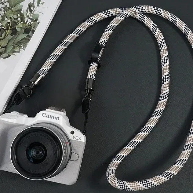 Braided nylon rope camera strap attached to a camera body with a split ring